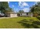 Inviting single-story home featuring a lush green lawn and a charming, neutral-toned exterior at 5208 S 82Nd St, Tampa, FL 33619