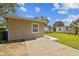 View of the exterior with a long driveway leading to the side of the house and fenced yards at 5208 S 82Nd St, Tampa, FL 33619