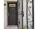 Close-up of the front door with a decorative security gate and welcoming 'Welcome' sign at 5208 S 82Nd St, Tampa, FL 33619