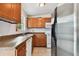 Well-equipped kitchen features wood cabinets, granite countertops, and stainless steel refrigerator at 5208 S 82Nd St, Tampa, FL 33619