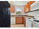 Functional kitchen with wood cabinets, appliances, and a window offering natural light at 5208 S 82Nd St, Tampa, FL 33619