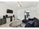 Cozy living room features a black couch, tile flooring, and a mounted television at 5208 S 82Nd St, Tampa, FL 33619