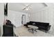 This living room features tile flooring, geometric-patterned walls, and a comfortable black couch at 5208 S 82Nd St, Tampa, FL 33619