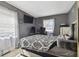 The main bedroom boasts a decorative gray wall, patterned comforter, and a view of the window at 5208 S 82Nd St, Tampa, FL 33619