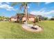 Rear view of an attractive single-story home featuring a lush green lawn and tastefully landscaped surroundings at 5444 90Th Avenue E Cir, Parrish, FL 34219