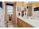 Bathroom with a single sink vanity, white countertops, and a window providing natural light at 5444 90Th Avenue E Cir, Parrish, FL 34219