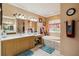 Bright bathroom features double sinks, wood cabinets, a soaking tub, and lots of natural light at 5444 90Th Avenue E Cir, Parrish, FL 34219