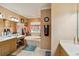 This bathroom includes a soaking tub under a window, and and vanity at 5444 90Th Avenue E Cir, Parrish, FL 34219