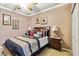 Bedroom features a ceiling fan, crown molding, and coordinated decor at 5444 90Th Avenue E Cir, Parrish, FL 34219