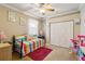 Bright bedroom with a striped daybed, ceiling fan, and ample closet space at 5444 90Th Avenue E Cir, Parrish, FL 34219