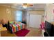 Bright bedroom with colorful bedding, play area, and a ceiling fan at 5444 90Th Avenue E Cir, Parrish, FL 34219