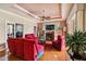 Spacious living room with cozy fireplace, large TV, and plush red seating at 5444 90Th Avenue E Cir, Parrish, FL 34219