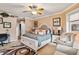 Spacious main bedroom featuring a decorative headboard, ceiling fan, and an ensuite bathroom at 5444 90Th Avenue E Cir, Parrish, FL 34219