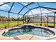 Relaxing screened-in pool with tiled accents and a tranquil view of the backyard and lake at 5444 90Th Avenue E Cir, Parrish, FL 34219