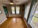 Bedroom featuring hardwood floors and three windows allowing natural light into the space at 5632 Indiana Ave, New Port Richey, FL 34652