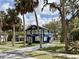 Two-story blue home with white trim and a bright yellow door, surrounded by mature trees at 5632 Indiana Ave, New Port Richey, FL 34652