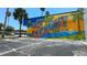 Colorful mural welcomes visitors to New Port Richey, Florida, with palm trees and a sunny beach scene at 5632 Indiana Ave, New Port Richey, FL 34652