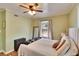 A stylish bedroom features light green walls, ceiling fan, and hardwood floors at 707 E Calhoun St, Plant City, FL 33563