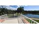 Balcony overlooking a lush landscape and serene lake, perfect for relaxation at 7279 Maidencane Ct, Seminole, FL 33777