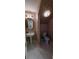 Powder bathroom featuring pedestal sink, octagon mirror, and tiled floor at 7279 Maidencane Ct, Seminole, FL 33777