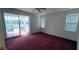 Bedroom with red carpet, sliding glass door to patio and backyard at 7279 Maidencane Ct, Seminole, FL 33777