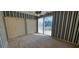 Bedroom featuring closet and sliding glass door to balcony and blue-striped wallpaper at 7279 Maidencane Ct, Seminole, FL 33777