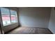 Bright bedroom with a large window, letting in plenty of natural light with carpeted floors at 7279 Maidencane Ct, Seminole, FL 33777
