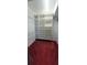 Spacious walk-in closet featuring built-in shelving and red carpet at 7279 Maidencane Ct, Seminole, FL 33777