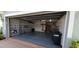 View of the garage with open door, storage cabinets, and door to the house at 7279 Maidencane Ct, Seminole, FL 33777