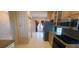 View from kitchen to formal dining and living area, with tile floors and chandelier at 7279 Maidencane Ct, Seminole, FL 33777