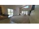 Open floor plan with a view of the kitchen, two-story ceilings, and large windows at 7279 Maidencane Ct, Seminole, FL 33777