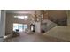Living room featuring a chandelier, large windows, staircase, and sliders to the backyard at 7279 Maidencane Ct, Seminole, FL 33777