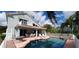 View of the pool, patio, and the rear of the house, showing a small balcony at 7279 Maidencane Ct, Seminole, FL 33777