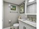 Nicely updated bathroom with a granite countertop vanity and medicine cabinet mirror at 7300 Sun Island S Dr # 1705, South Pasadena, FL 33707