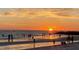 A scenic beach at sunset with people enjoying the water and sand at 7300 Sun Island S Dr # 1705, South Pasadena, FL 33707
