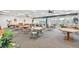 A bright and airy community room with tables, chairs, and a view of the outdoors at 7300 Sun Island S Dr # 1705, South Pasadena, FL 33707