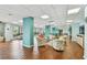 A spacious community room featuring hardwood floors, comfortable seating, and bright windows at 7300 Sun Island S Dr # 1705, South Pasadena, FL 33707