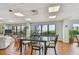 A lovely communal dining area featuring a glass top table and seating with views out the windows at 7300 Sun Island S Dr # 1705, South Pasadena, FL 33707