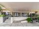 Building entrance with covered parking, ramp access, and comfortable seating at 7300 Sun Island S Dr # 1705, South Pasadena, FL 33707