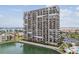 High-rise condo building with numerous private balconies overlooking the canal and surrounding community at 7300 Sun Island S Dr # 1705, South Pasadena, FL 33707