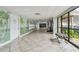 Well-lit hallway featuring tropical-themed murals, tile floors, and comfortable seating near a large window at 7300 Sun Island S Dr # 1705, South Pasadena, FL 33707