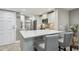 Well-lit kitchen with modern island seating, stainless steel appliances, and ample cabinet space at 7300 Sun Island S Dr # 1705, South Pasadena, FL 33707