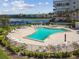 Aerial view of community pool with ample seating, spa, and beautiful landscaping at 7300 Sun Island S Dr # 1705, South Pasadena, FL 33707