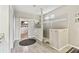 Bright bathroom featuring a walk-in shower, tiled walls, and a view into the spacious walk-in closet at 8100 Olive Brook Dr, Wesley Chapel, FL 33545