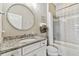 Bathroom vanity with a granite counter, stainless steel fixtures, and a combined tub and shower at 8100 Olive Brook Dr, Wesley Chapel, FL 33545