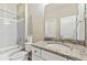 Bathroom vanity with a granite counter, stainless steel fixtures, and a combined tub and shower at 8100 Olive Brook Dr, Wesley Chapel, FL 33545