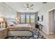 Main bedroom featuring a ceiling fan, shiplap accent wall, multiple windows and natural light at 8100 Olive Brook Dr, Wesley Chapel, FL 33545