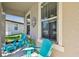 Relaxing front porch featuring blue Adirondack chairs, perfect for enjoying the outdoors at 8100 Olive Brook Dr, Wesley Chapel, FL 33545
