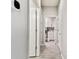 Hallway featuring stylish flooring with doorways to a laundry room and other rooms at 8100 Olive Brook Dr, Wesley Chapel, FL 33545