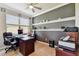 Comfortable home office with a large desk, rolling chairs, shelving and a bright window at 8100 Olive Brook Dr, Wesley Chapel, FL 33545